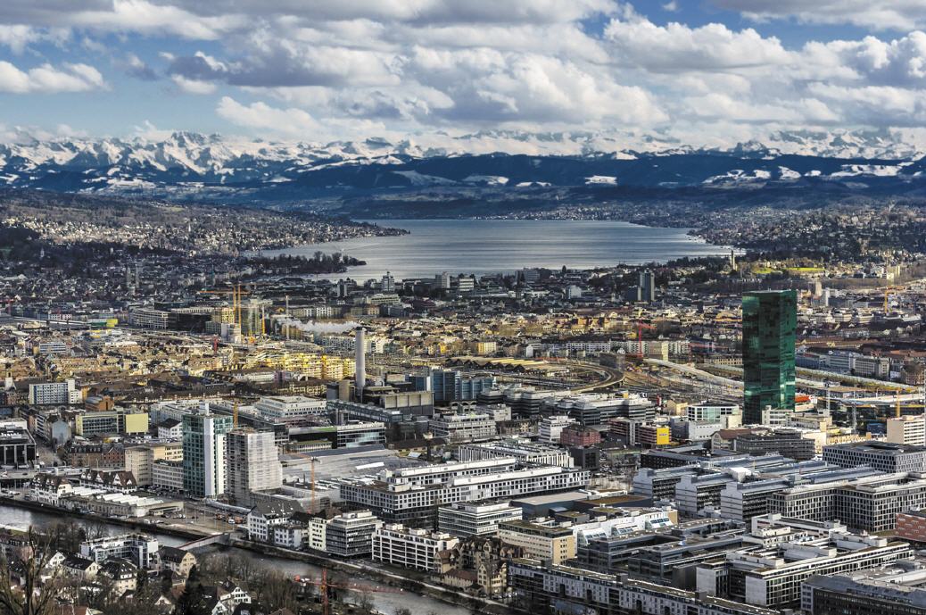 Blick auf Stadt und See mit Alpenpanorama
